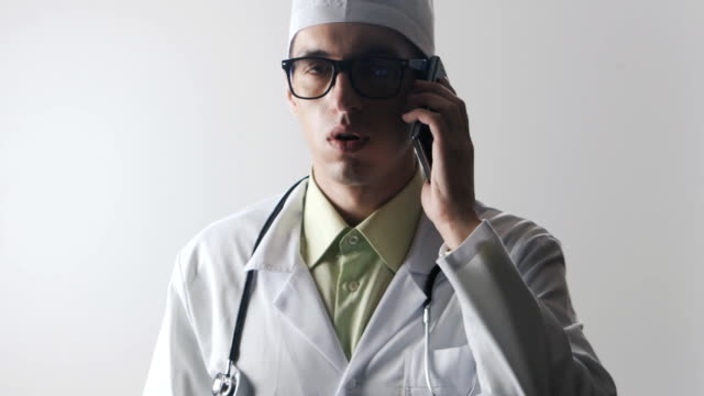 The-doctor-speaks-on-a-mobile-phone.-A-medical-worker-makes-a-phone-consultation.