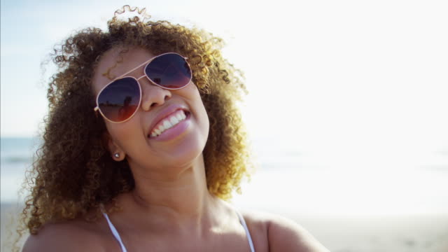 African-American-female-enjoying-summer-using-smart-phone