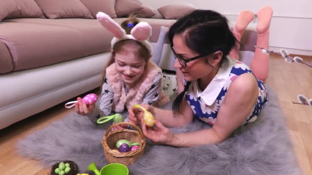 Mother-and-daughter-with-Easter-eggs-in-basket-no-floor