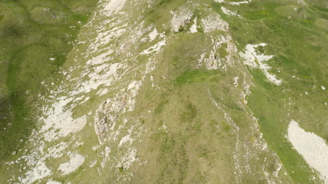 Flying-over-a-large-rock-formation-among-the-green-fields.-Russia.-North-Caucasus-Video-from-the-drone