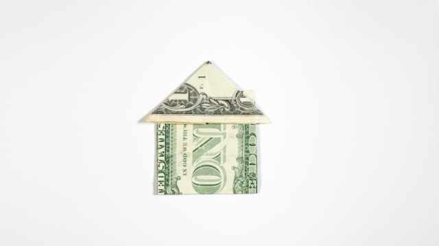 Folding-an-Origami-House-from-One-Dollar-Bill-(dollar-bill-origami)---symbol-for-real-estate-finances,-mortgage-payments