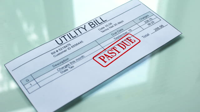 Utility-bill-past-due,-hand-stamping-seal-on-document,-payment-for-services