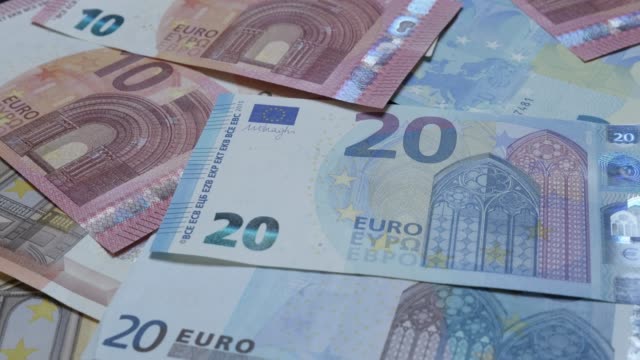 Business-success-and-money-background-made-of-Euro-banknotes-4K-2160p-30fps-UltraHD-video---Slow-tilt-over-European-currency-denominations-4K-3840X2160-UHD-footage