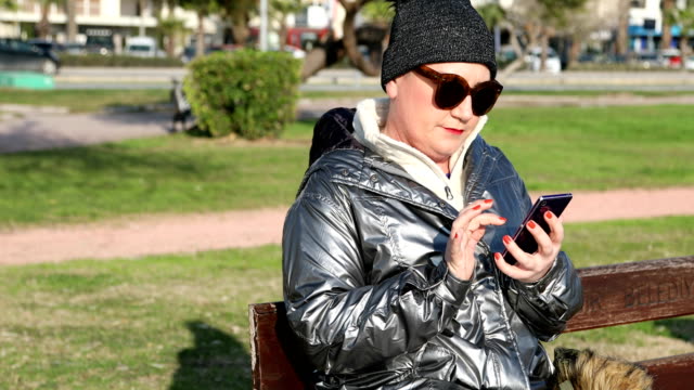 Woman-using-smartphone-at-the-outdoor