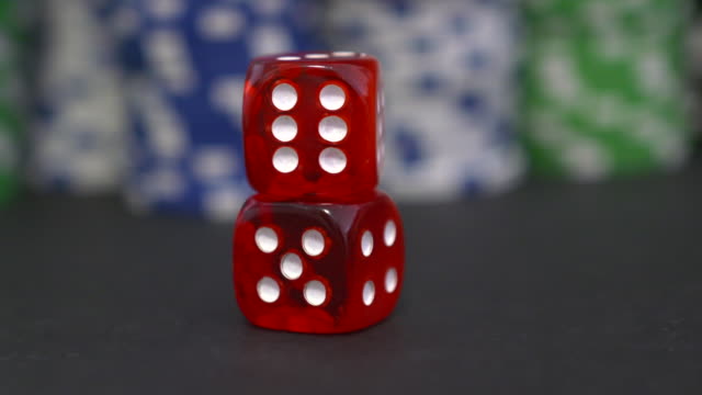 Two-red-dice-on-the-background-of-the-poker-game