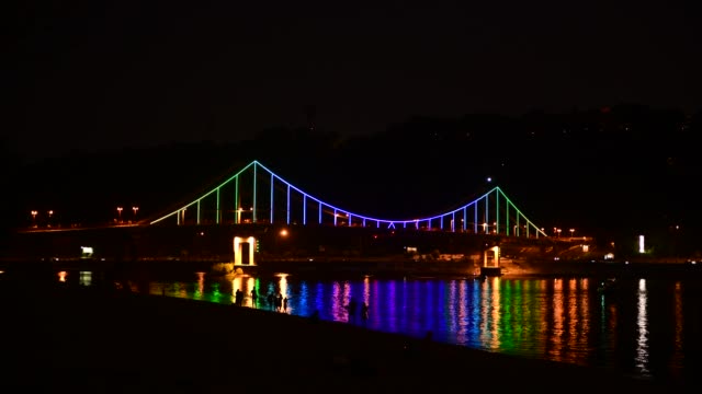 Kiev-pedastrian-bridge-illumination-on-Dnipro-river-reflection-Ukraine-travel