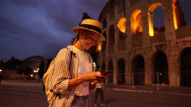 Lächelnde-kaukasische-junge-Frau-genießt-zu-Fuß-in-Rom-mit-App-auf-smartphone-für-die-Suche-Routen-online-über-gute-4G-Internetverbindung-im-Roaming