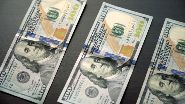Us-dollar-bills-on-table-and-camera-is-sliding-slowly