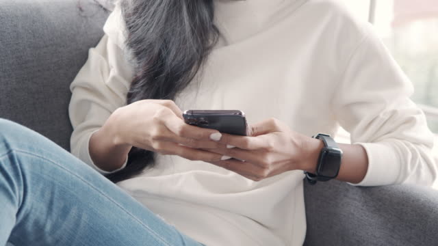 Close-up-asian-girl-using-smartphone-browsing-social-media-communication.