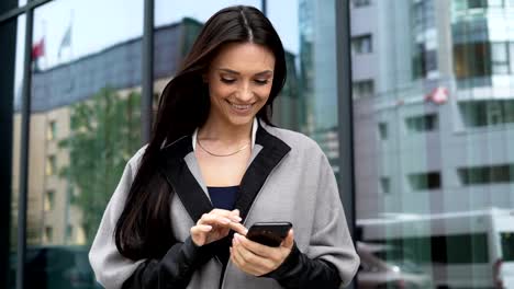 Beautiful-woman-with-phone-near-business-centre