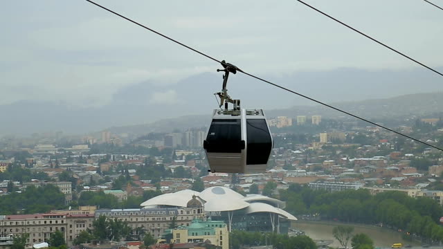 Small-cable-car-running-along-cableroad-transporting-tourists-and-city-residents