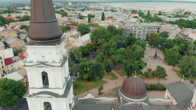 Old-european-city-aerial-sightseeing.-Flying-above-centre-district.-Drone-view.-Sea-on-horizon.-Close-up-ancient-christian-cathedral-building