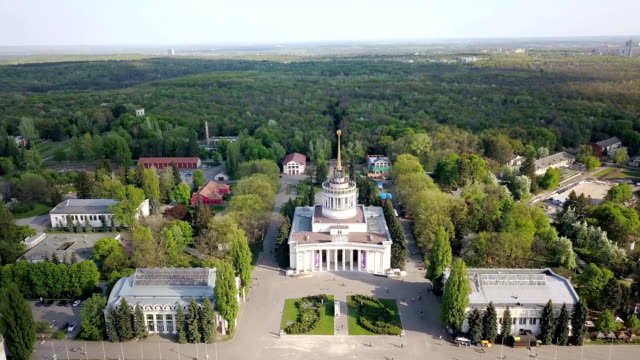 Panoramic-video-from-the-drone-above-the-central-square-and-recreational-areas-of-the-National-Exhibition-Center-in-Kiev,-Ukraine.-Slow-motion-view-from-drone-in-FullHD-video