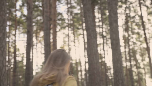 Walking-girl-in-the-sunny-forest-way-slow-motion
