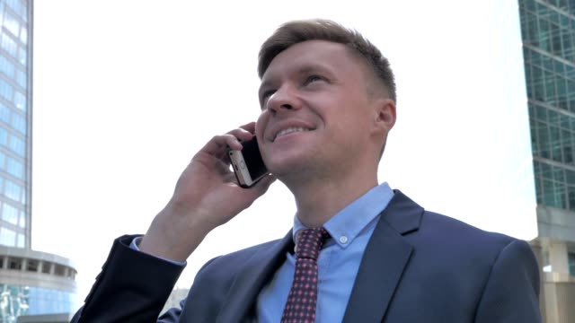 Happy-Businessman-Talking-on-Phone