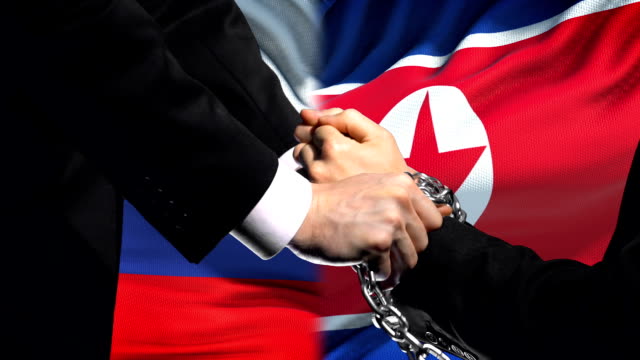 Russia-sanctions-North-Korea,-chained-arms,-political-or-economic-conflict