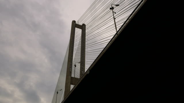 Big-bridge-over-the-river.-Architectural-building-connecting-the-two-banks-of-the-city.-Massive-structure.-A-truck-is-carrying-cargo-across-the-bridge.