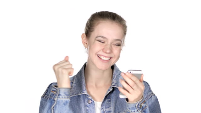 Casual-Young-Woman-Excited-for-Success-while-Using-Smartphone