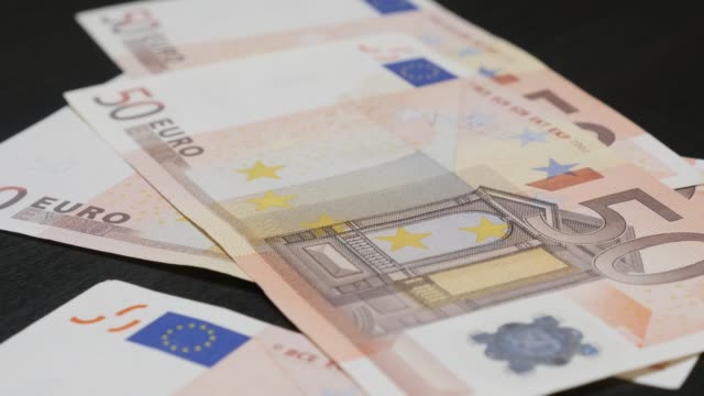 Lot-of-Euro-paper-money-counting-in-different-values-in-4K-3840X2160-UHD-footage---Lot-of-European-Union-banknotes-falling-on-table-4K-2160p-30fps-UltraHD-video