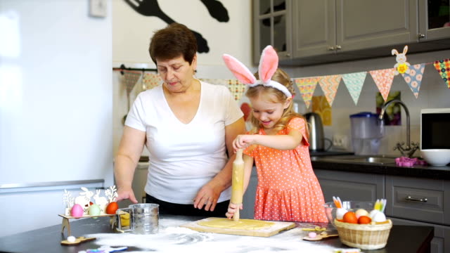 Little-Girl-Rolling-Out-a-Dough-with-Grandmother
