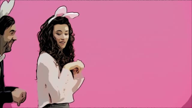 A-young-lovers-couple-appears-on-the-pink-background,-reproducing-horses-of-hares.-With-the-ears-of-a-pink-rabbit-on-the-head.-Easter-concept.