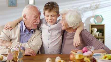 Little-Boy-Hugging-Grandparents-at-Easter