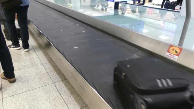 COPENHAGEN,-DENMARK---MARCH-2019:-Luggage-tape-in-the-airport-terminal.-Baggage-rides-on-the-issue-tape.-Baggage-claim