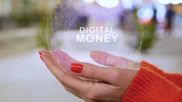 Female-hands-holding-hologram-with-text-Digital-money