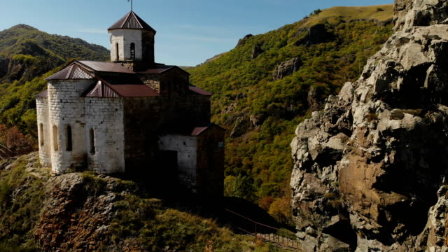 4K-UHD-Aerial-view-of-a-mountain-monastery-standing-on-a-cliff