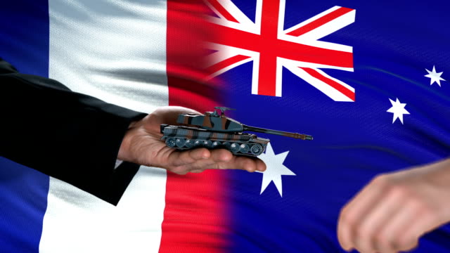 France-and-Australia-officials-exchanging-tank-money,-flag-background,-support
