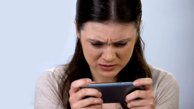 Gadget-addicted-woman-playing-video-game-on-smartphone,-modern-technology