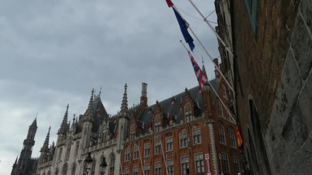 Bruges,-Belgium---May-2019:-View-of-the-Gruuthuse-Palace.-The-area-is-farther-by-the-palace.-Tourists-walk.