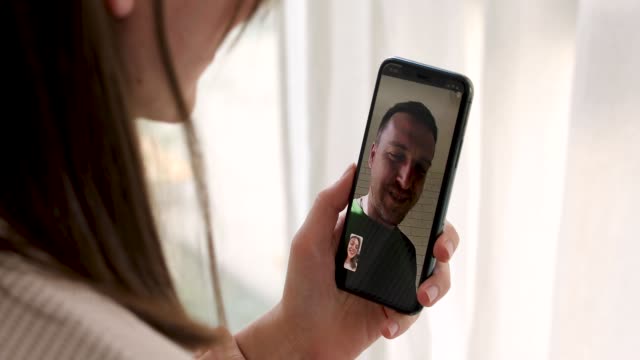 Woman-talking-to-a-man-on-a-video-call-smartphone