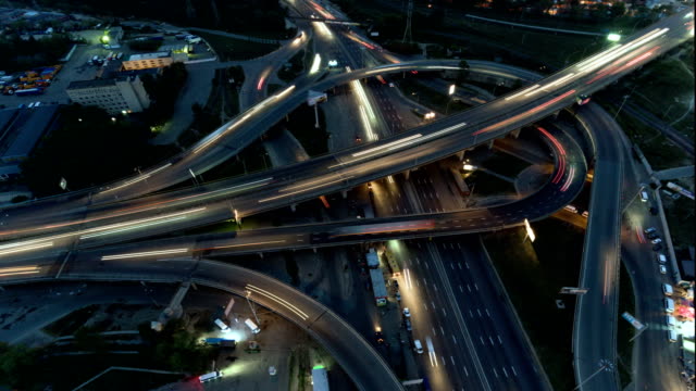 Vertical-top-down-aerial-view-of-traffic-on-freeway-interchange-at-night.