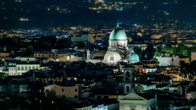 Synagogue-of-Florence-night-timelapse-with-green-copper-dome-rising-above-surrounding-suburban-housing