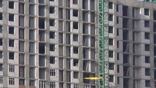 Construction-of-a-high-rise-apartment-house.-The-construction-crane-works-at-the-construction-site.-Construction-of-new-residential-property