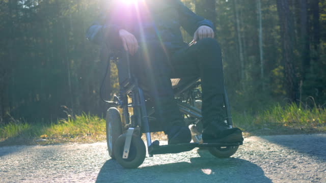 One-man-in-a-modern-wheelchair,-close-up.