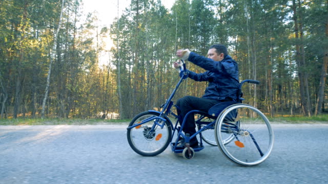 Paralyzed-patient-rides-special-medical-bicycle,-side-view.