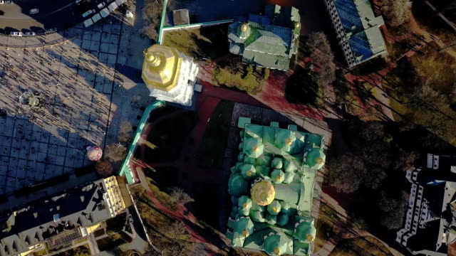 A-bird's-eye-view,-panoramic-video-from-the-drone-in-FullHD-to-the-Saint-Sophia's-Cathedral-Kiev,-Ukraine.-People-on-the-square-on-Easter-days.-Dolly-out-motion-and-drone-movement-counter-clockwise.