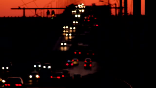 Night-traffic-defocused.-Many-cars-moving-along-bridge
