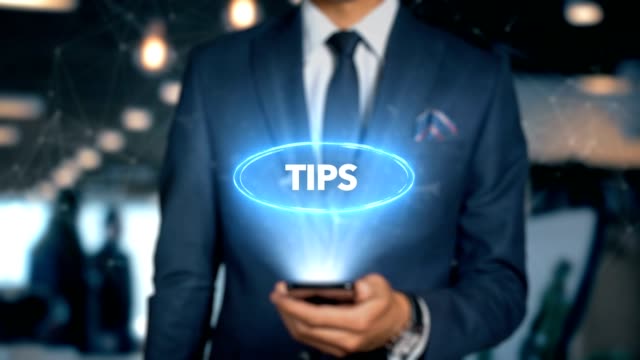 Businessman-With-Mobile-Phone-Opens-Hologram-HUD-Interface-and-Touches-Word---TIPS
