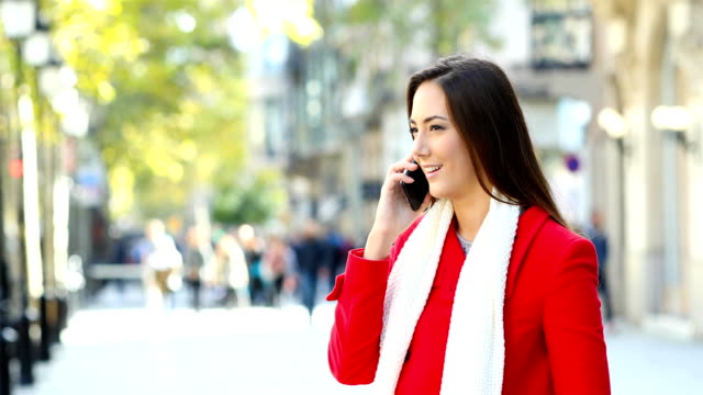Woman-talking-on-phone-in-the-street-in-winter