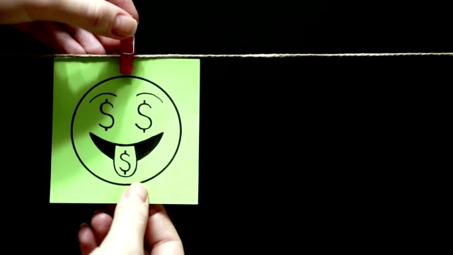 Two-stickers.-Emotions.-On-the-green-sheet-on-the-face-expression-love-of-money.-On-the-right-yellow-page-is-the-percent-symbol.-Black-background.