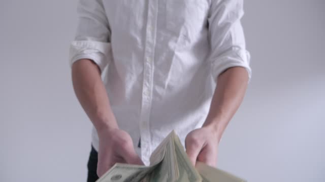 Rich-Man-throwing-money-on-a-white-background-in-slow-motion