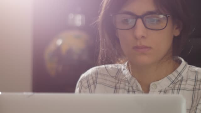Close-up-footage-of-female-with-glasses-looking-at-computer