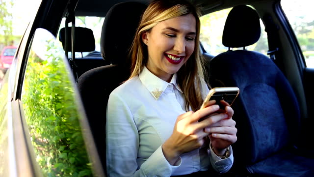 Woman-typing-a-message-in-car