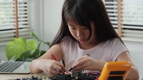 Little-girl-working-at-laboratory-alone,-Assembling-and-Testing-to-equipment-in-workshop.-People-with-technology-and-innovation-concept.