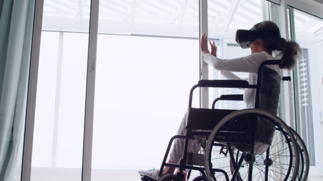 Mature-woman-in-a-wheelchair-using-VR