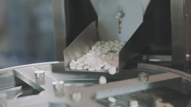 Production-of-tablets-close-up.-Pharmacological-factory.-Conveyor-line-for-the-production-of-tablets