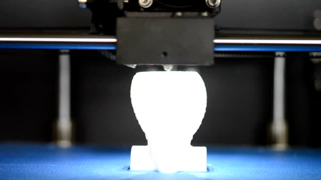 3D-printer-prints-the-form-of-white-plastic